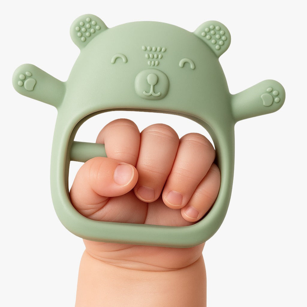 kiko no-drop newborn teether held by a baby's hand.